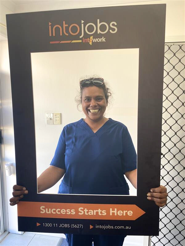 Allira posing for a photo inside the IntoJobs photo frame